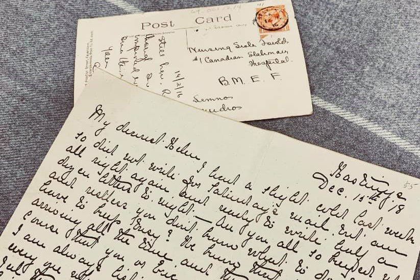 Photograph of a handwritten letter and envelope in the background.